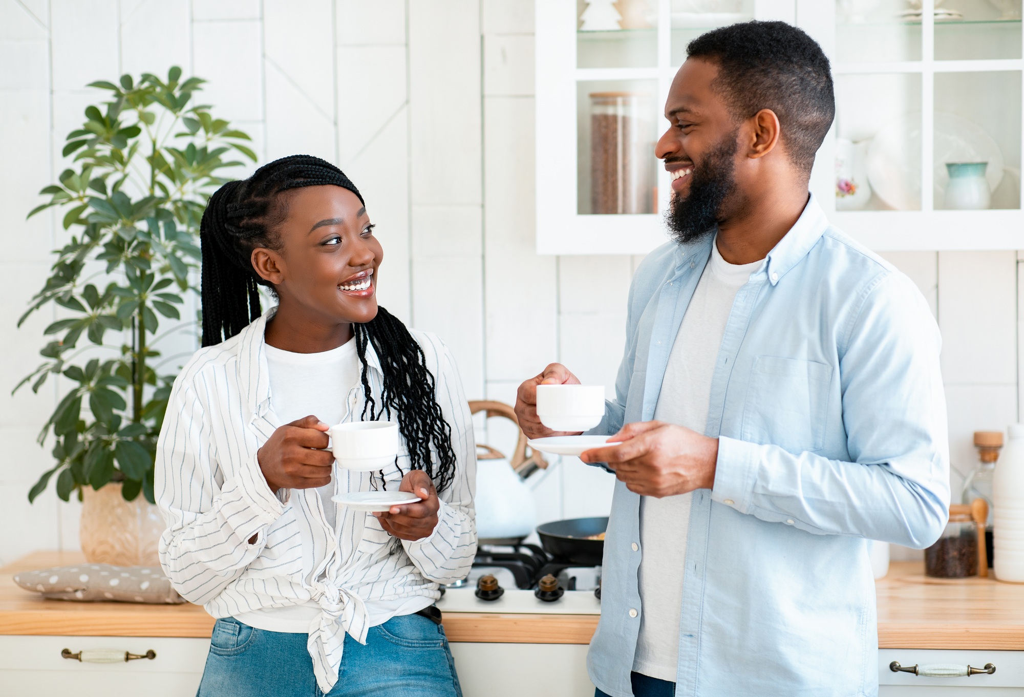 Couple's Daily Life. Happy Black Man And Woman Drinking Coffee In Kitchen